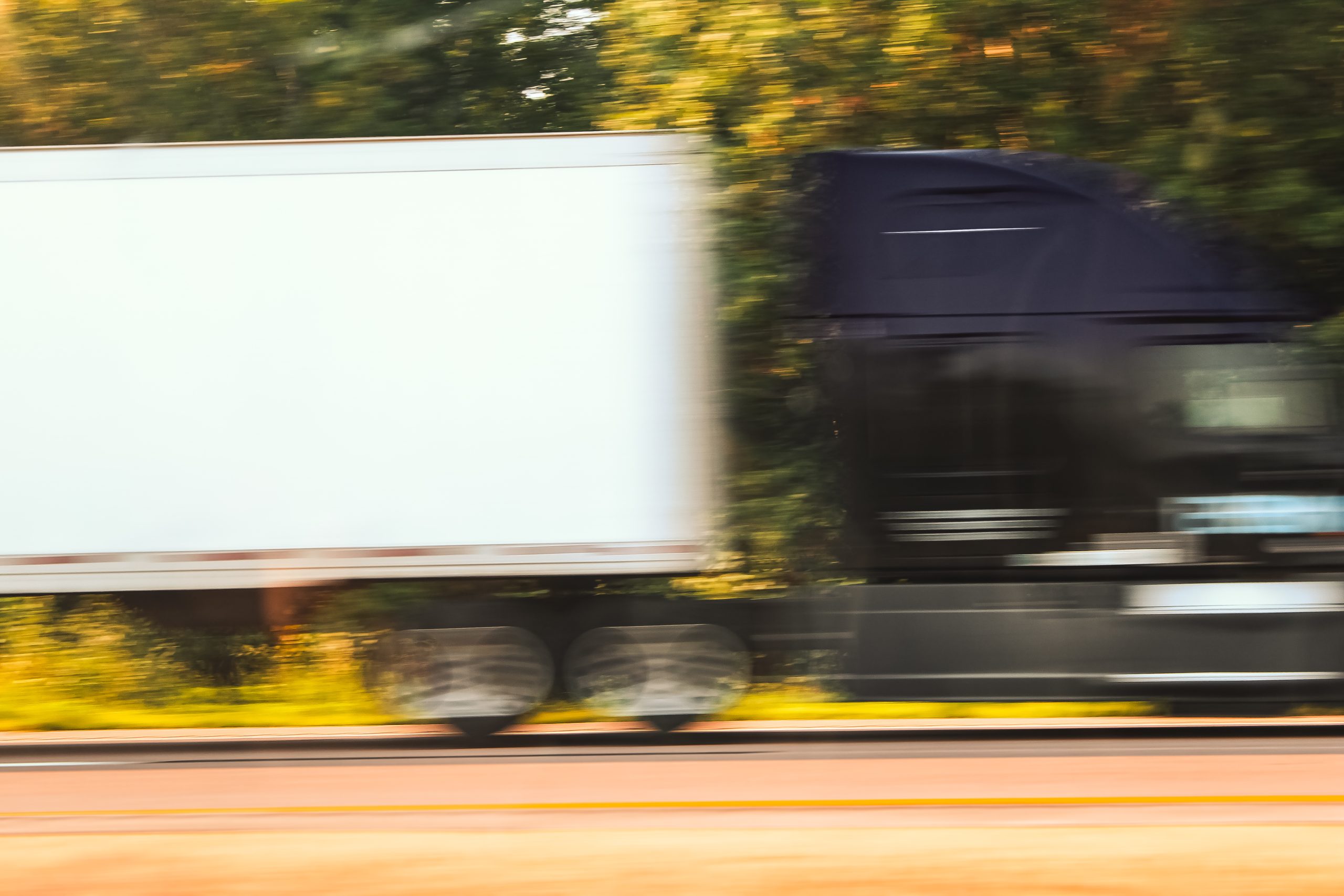 a semi-truck hauling in motion with a blurred background, suggesting speed. business and logistics design element specialty hauling